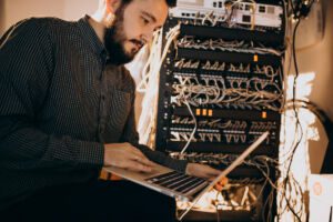 Young IT service man repairing computer