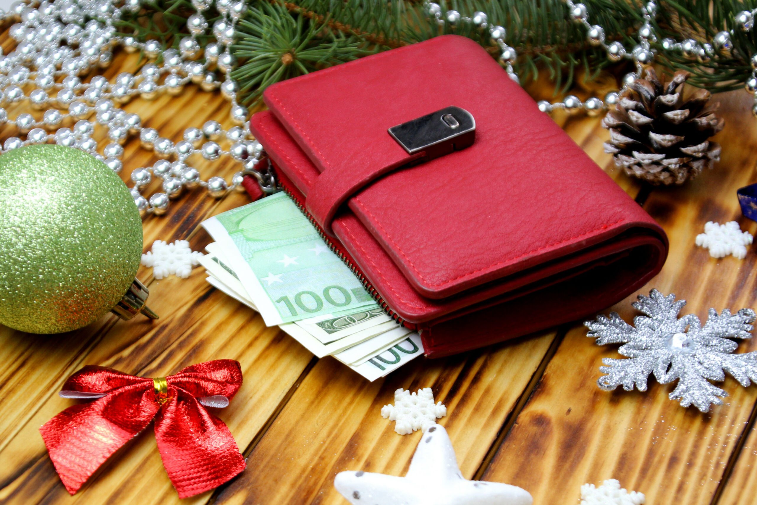 Red wallet with euro on the Christmas background