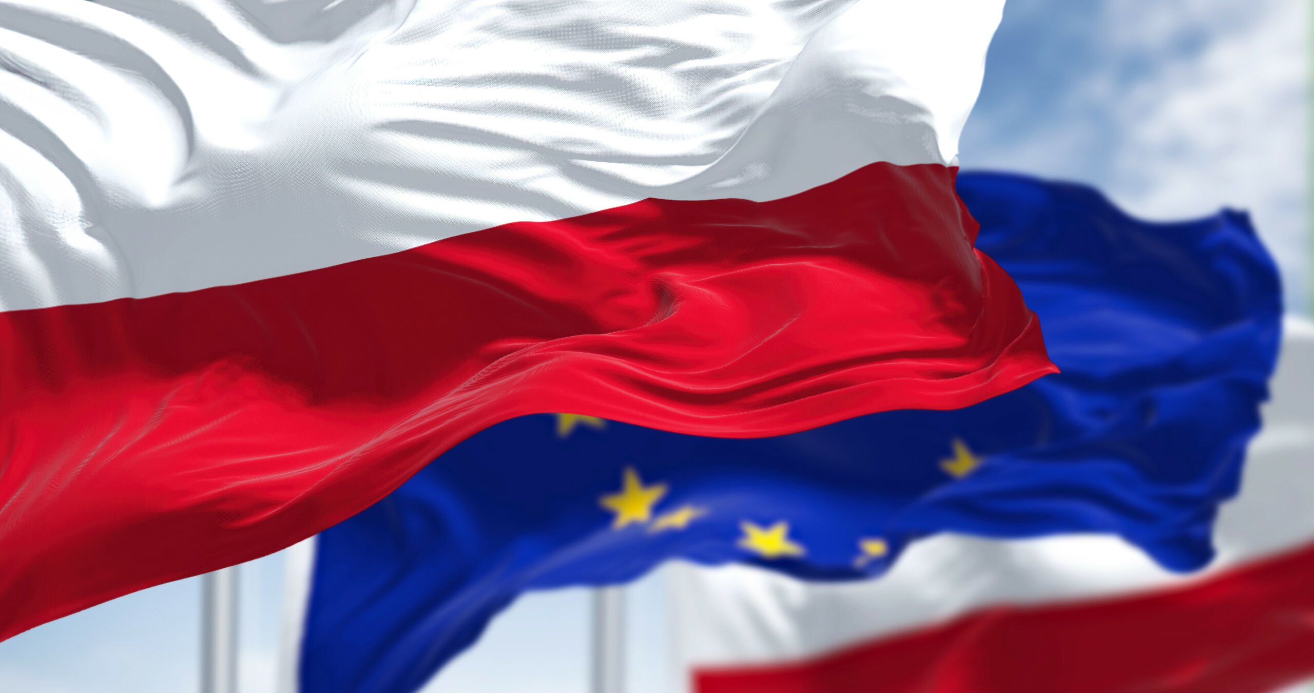 flying two Polish flags in the wind and in the middle of the EU