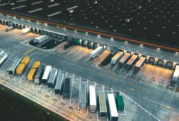 trucks parked outside warehouses in a distribution center
